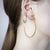 Unfinishing Line   Gold hoop sterling silver earring